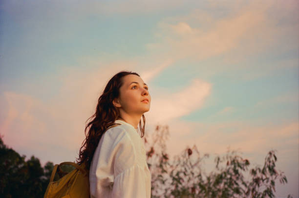 Serene woman looking at sunset with awe